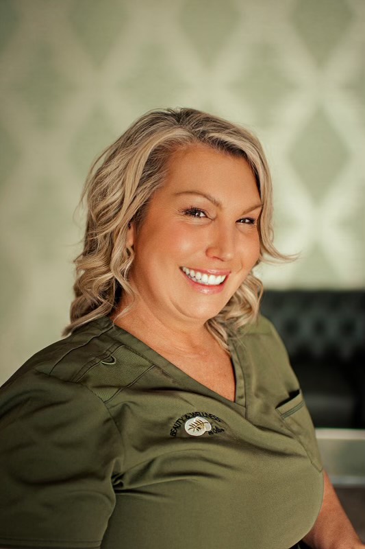 A woman with blonde hair smiling for the camera.